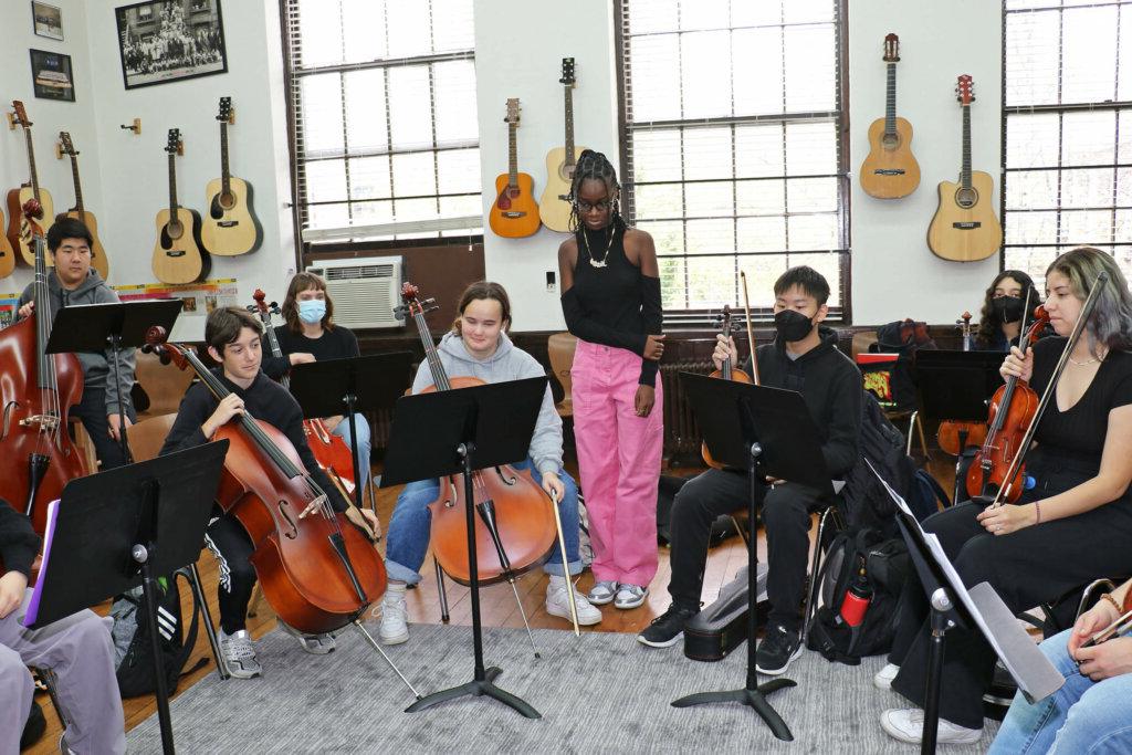 Jordan Millar listens as fellow students rehearse her string composition.